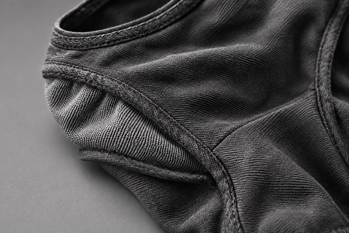 Close-up of the Deamon facemask’s stitched edges and textured grey fabric panels