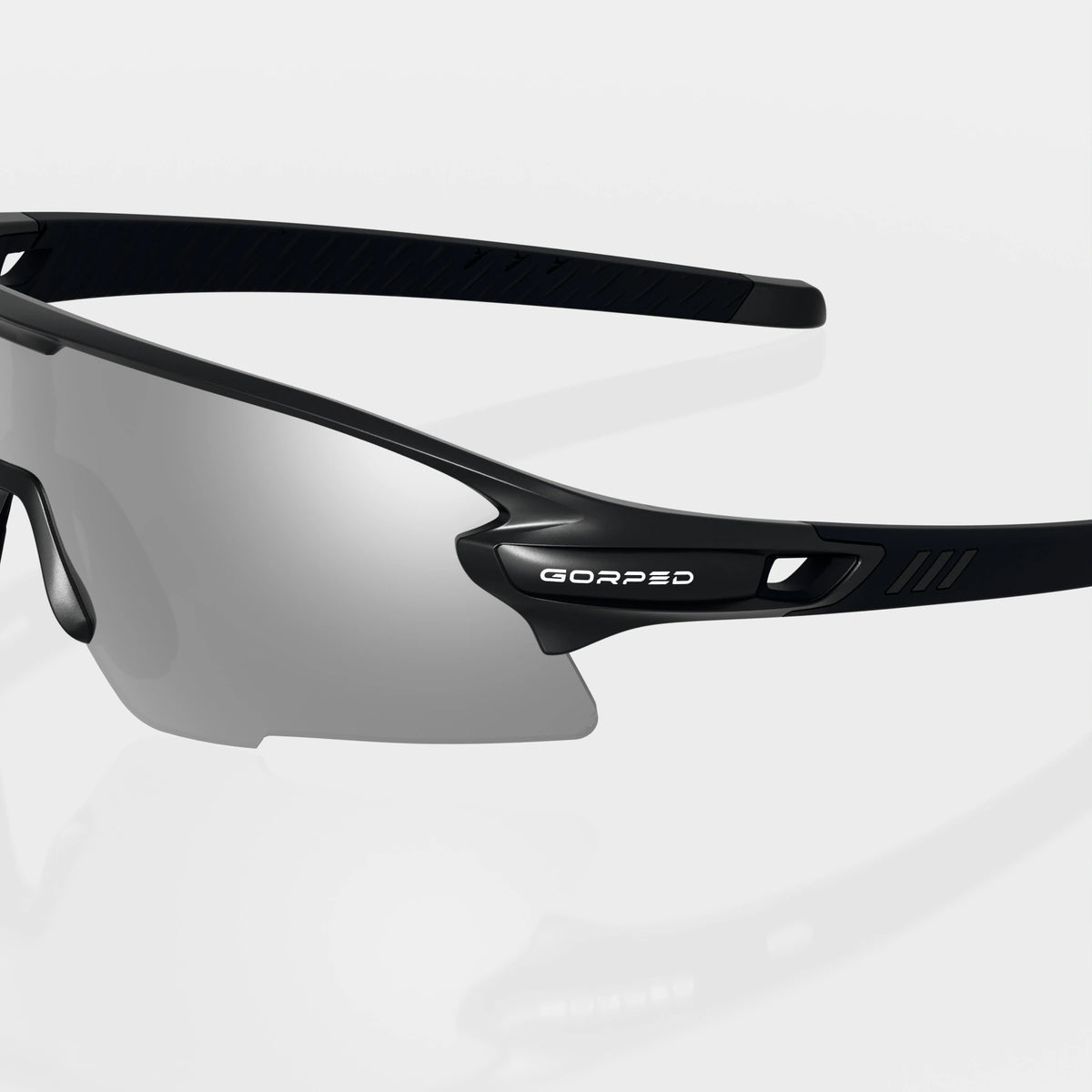 Strider Shadow sunglasses with a close view of the GORPED logo and temple on a pale studio background